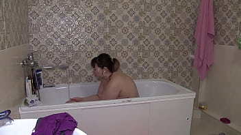 Big-belly A hidden camera in the bathroom spies on a mature BBW with a juicy PAWG Chubby milf washes for a long time and smokes a cigarette while lying in the bath Home fetish