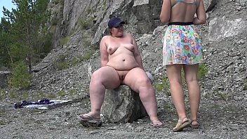 Public Lesbians with big asses in swimsuits sunbathe outdoors and fuck with a dildo. Orgasm in the clearing for a bbw girlfriend.